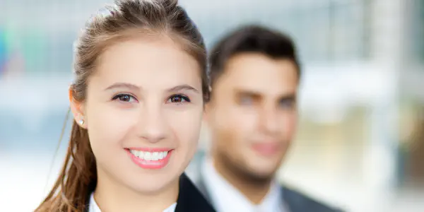 A Business Lady With A Man In The Background