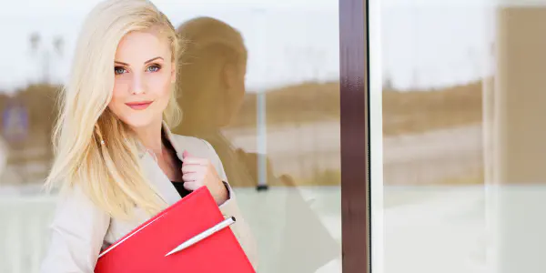 A Woman Holding A Red Folder